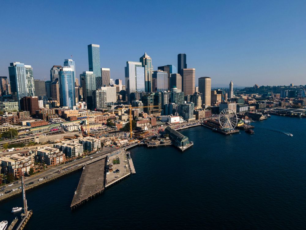 Aerial view of downtown San Diego skyline with modern high-rise buildings and waterfront piers on a clear day. Photo credit: Getty Images via Unsplash.