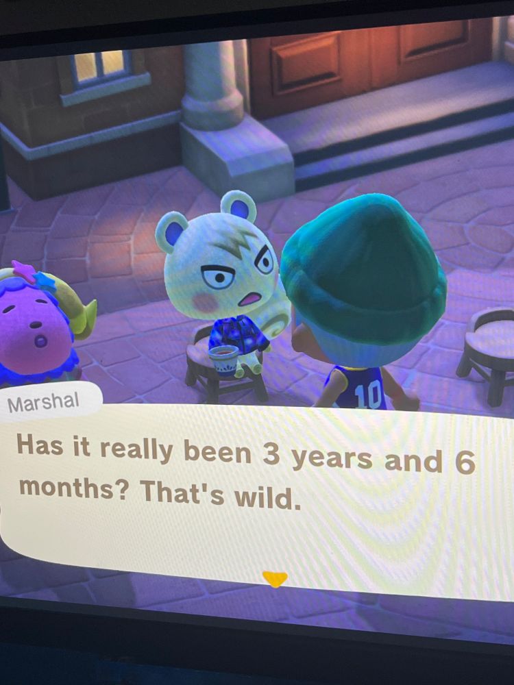 Sassy squirrel sitting in front of town hall in Animal Crossing New Horizons. 