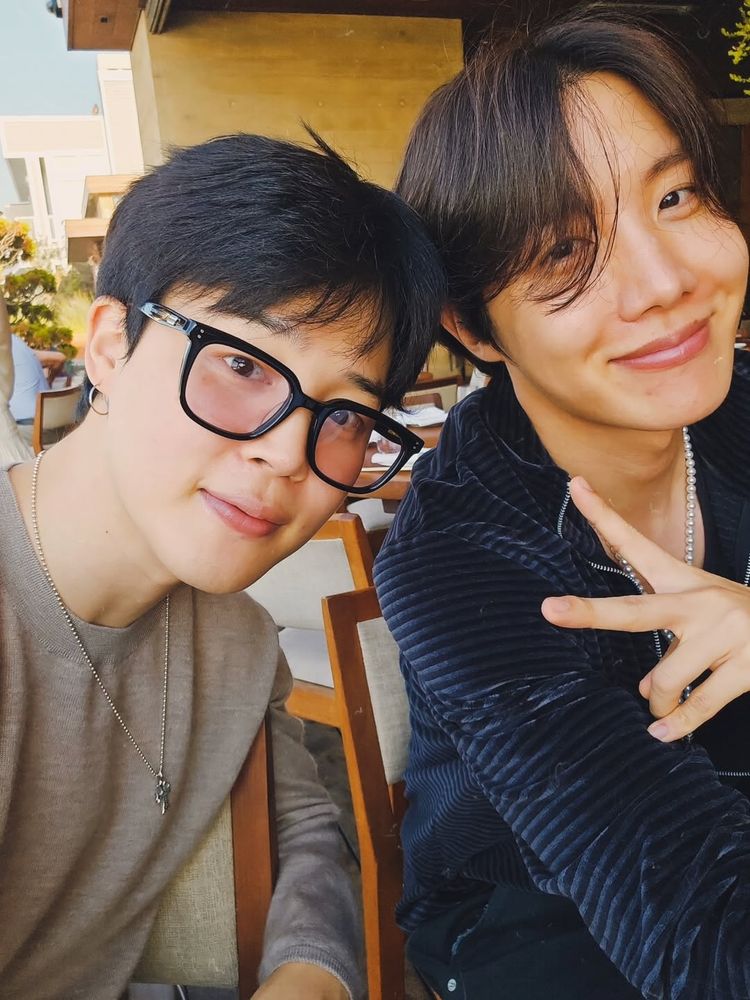 Jihope selca. They are cute and fluffy and smiling, barefaced, jomin has glasses, hobi doing peace sign. The vibe is soft and loving