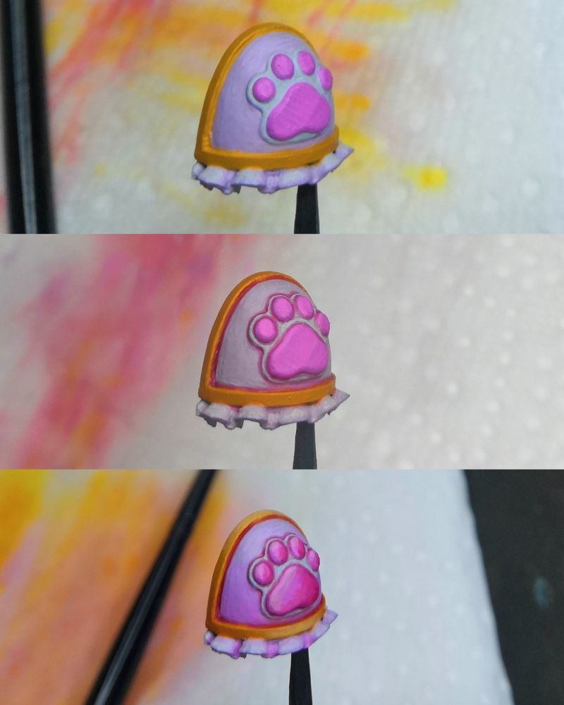 Various steps of painting a space Maid pauldron. 