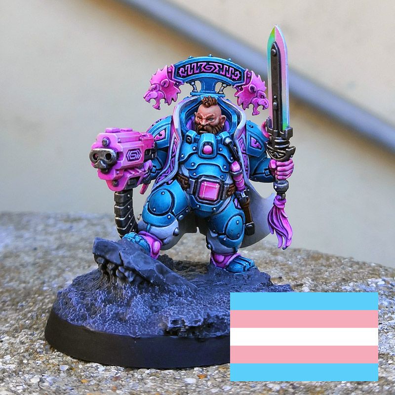 Warhammer40k mini from the votann faction painted using the color of the trans pride flag as color scheme.