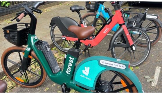 Forest and Voi e-bikes parked by the kerb