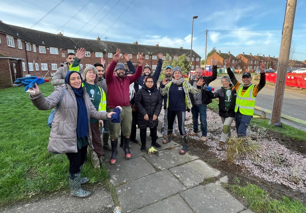 Group photo of residents cheering after planting session