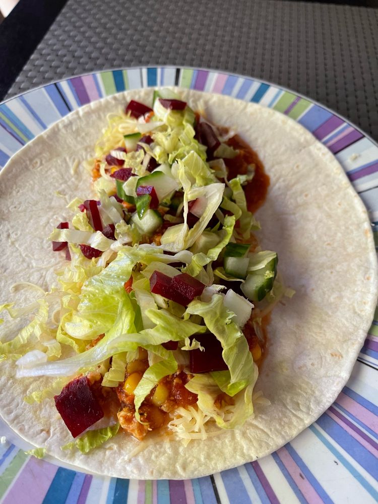 Chicken wrap with cheese, lettuce, beetroot and cucumber.