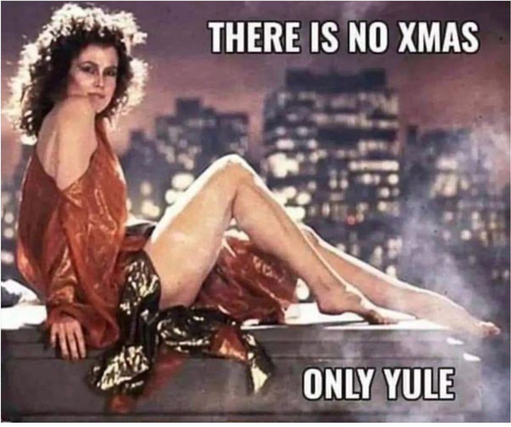 Sigourney Weaver as the character "Dana Barrett" in Ghostbusters wears a shiny red toga and sits atop the edge of a rooftop overlooking a city at night. Caption: THERE IS NO XMAS. ONLY YULE.