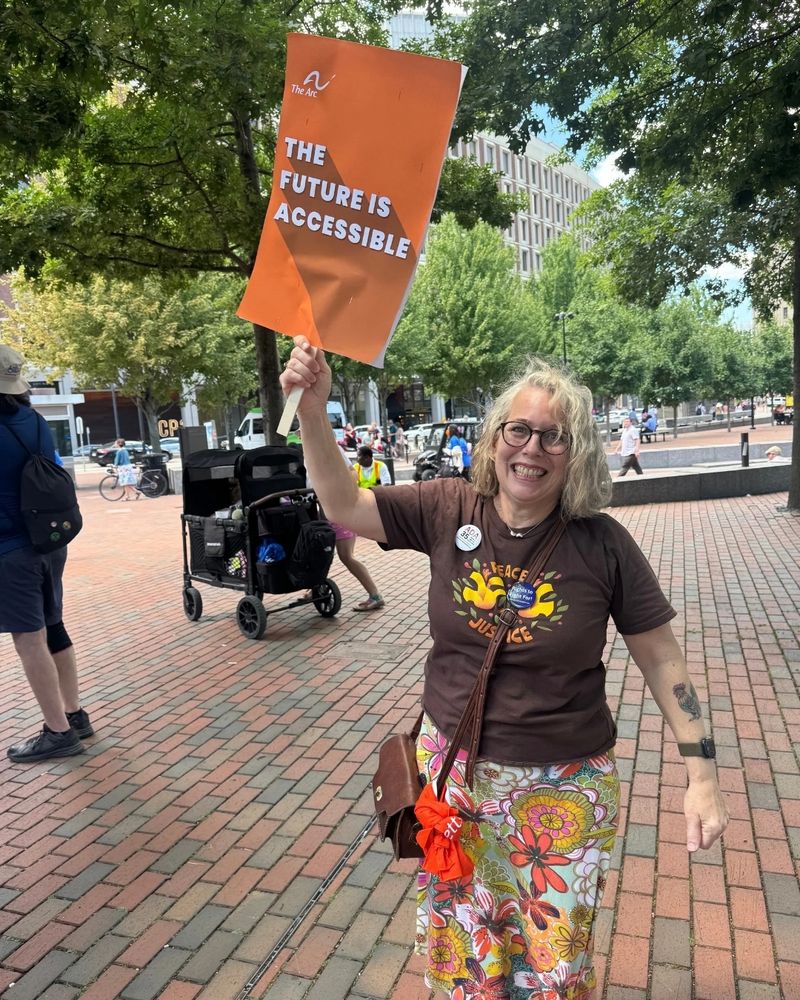 Wendy Peverill-Conti holds a sign that reads: “The Future is Accessible.”