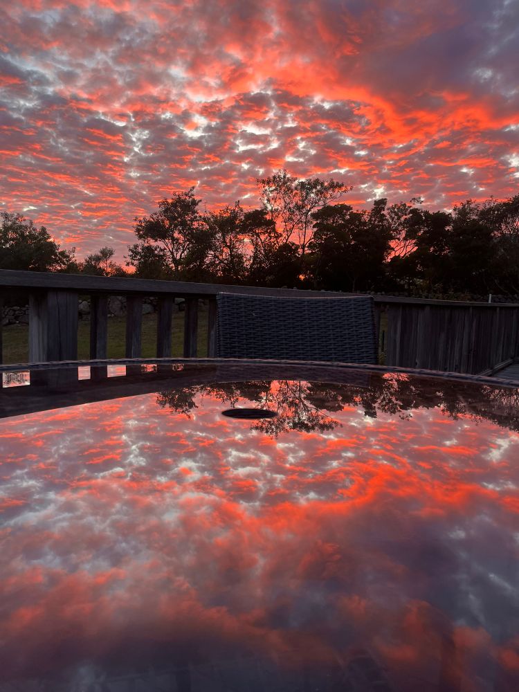 Orange sky reflecting on glass table.