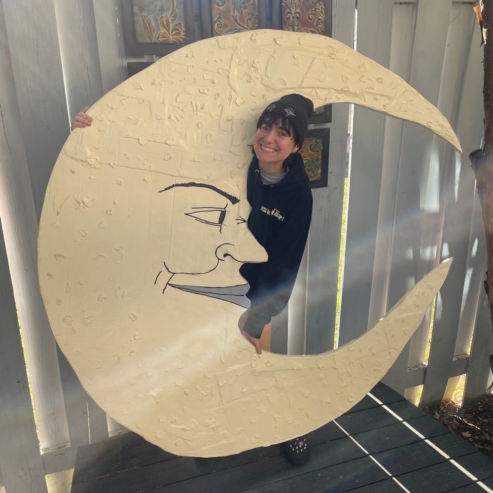 Me holding up a very large moon I made. It’s bigger than me