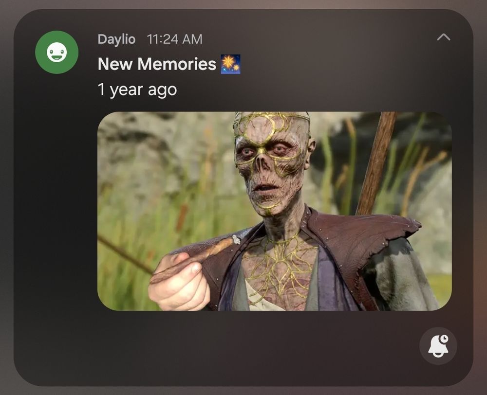a screenshot of a notification from the app Daylio that reads "New Memories - 1 year ago." below the text is the preview of an image of Withers from Baldur’s Gate 3 edited to have red sclera (as if he is high) and holding out a fat blunt.