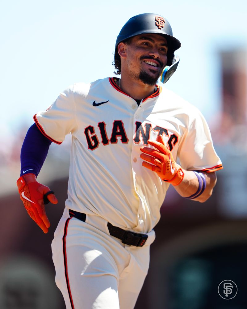 Adames smiling while rounding third on a home run