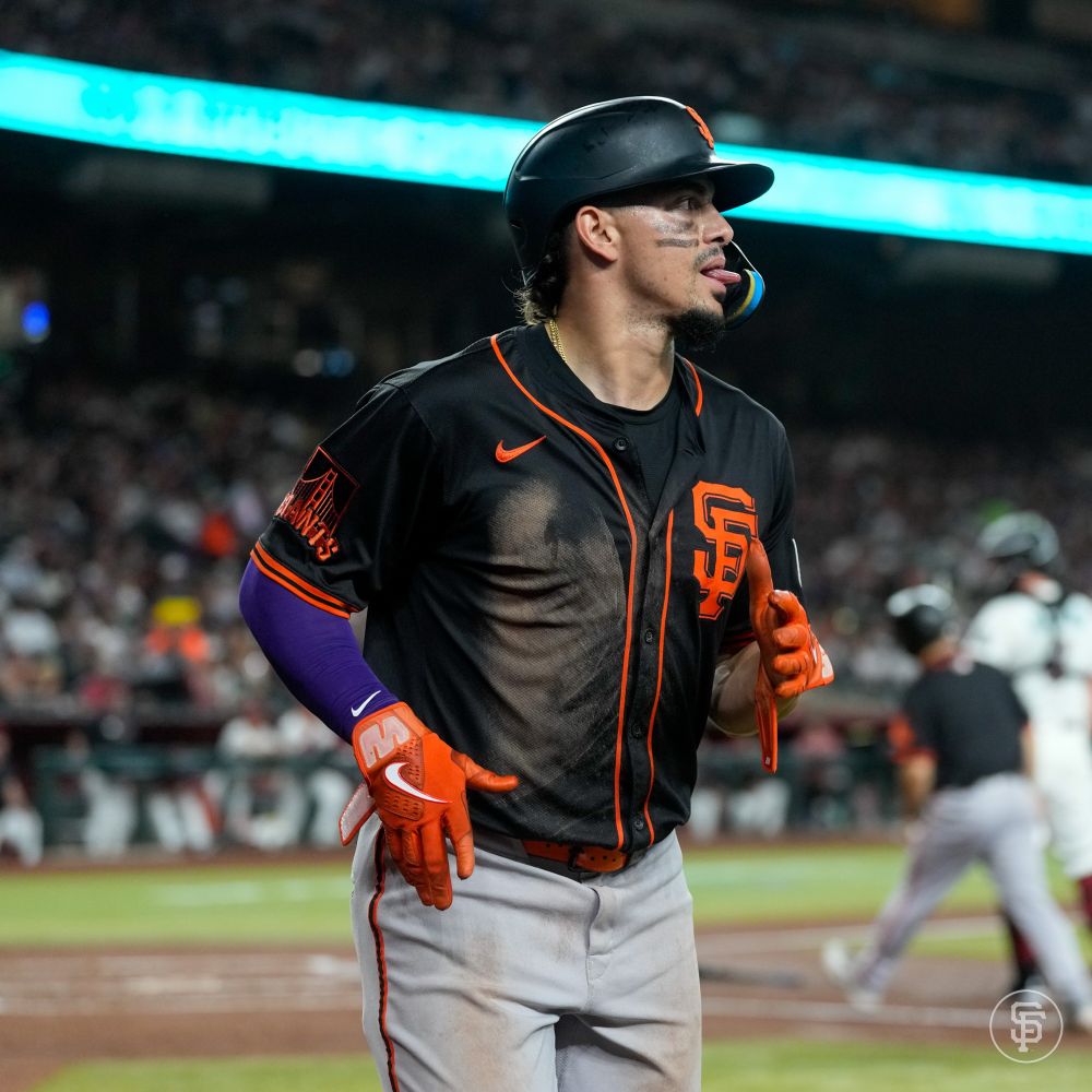 Willy Adames sticks out his tongue as he makes his way back to the dugout after scoring. 