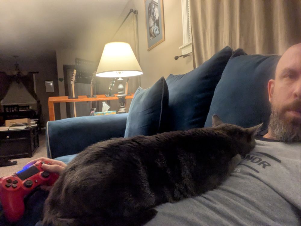 Calvin snoozing in my chest while I try to play video games without raging.