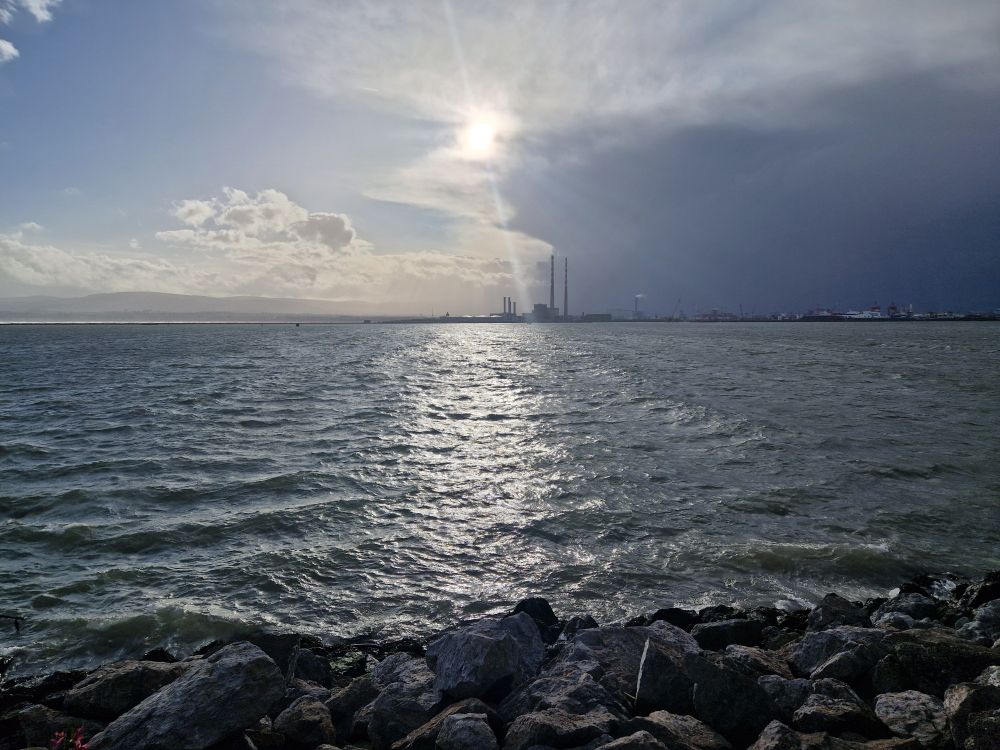 View of the Irish Sea from Bull Island Clontarf looking towards Poolbeg chimneys with stormy skies.