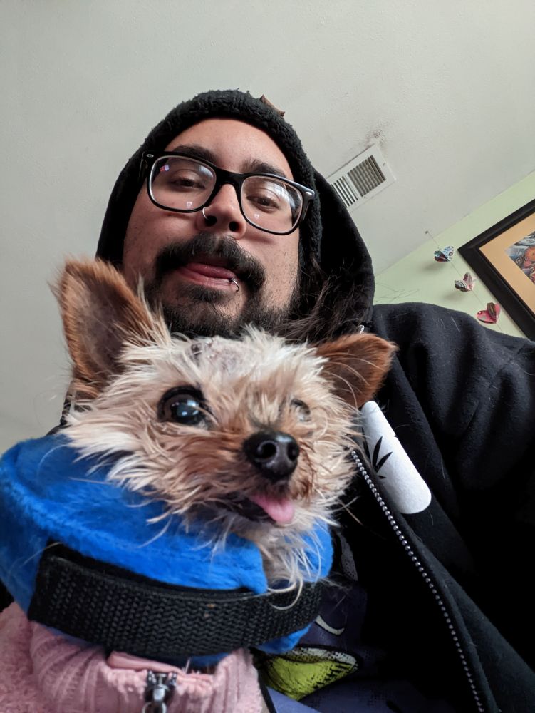 me and beanie

shortly after her stitches, you can see them at the top of her head

she has a plush blue ring around her neck and is wearing a pink sweater

suns out, so tongue is out