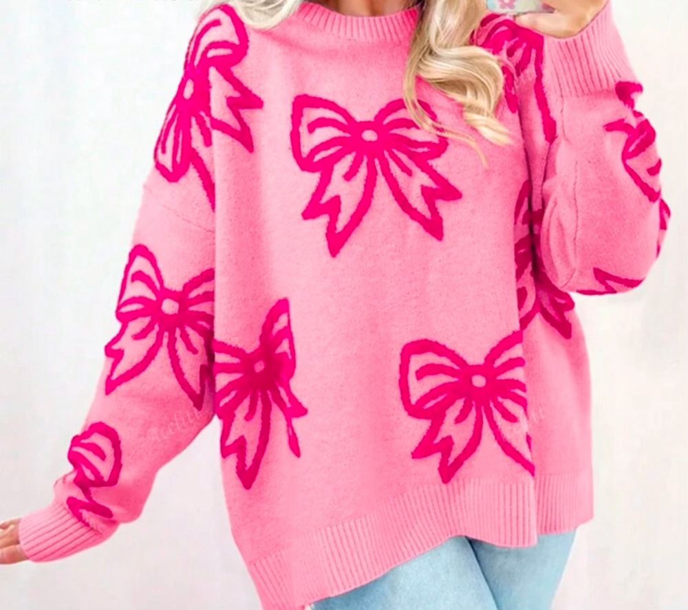 A lighter pink sweater covered in darker pink bow pattern