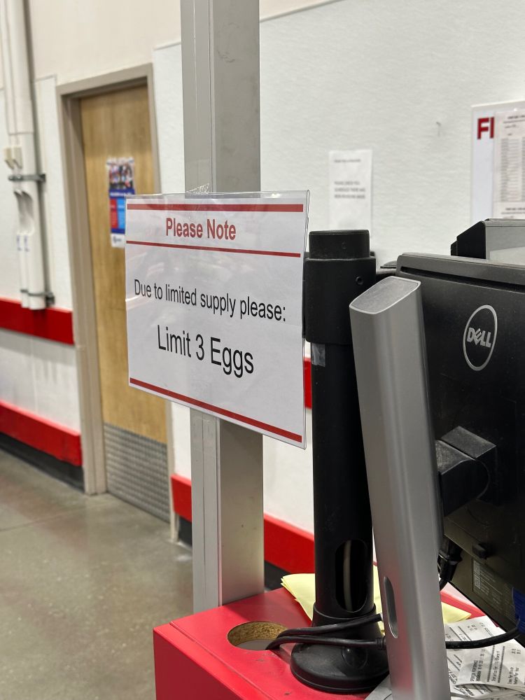 Placard at Costco saying “Due to limited supply please: Limit 3 Eggs”