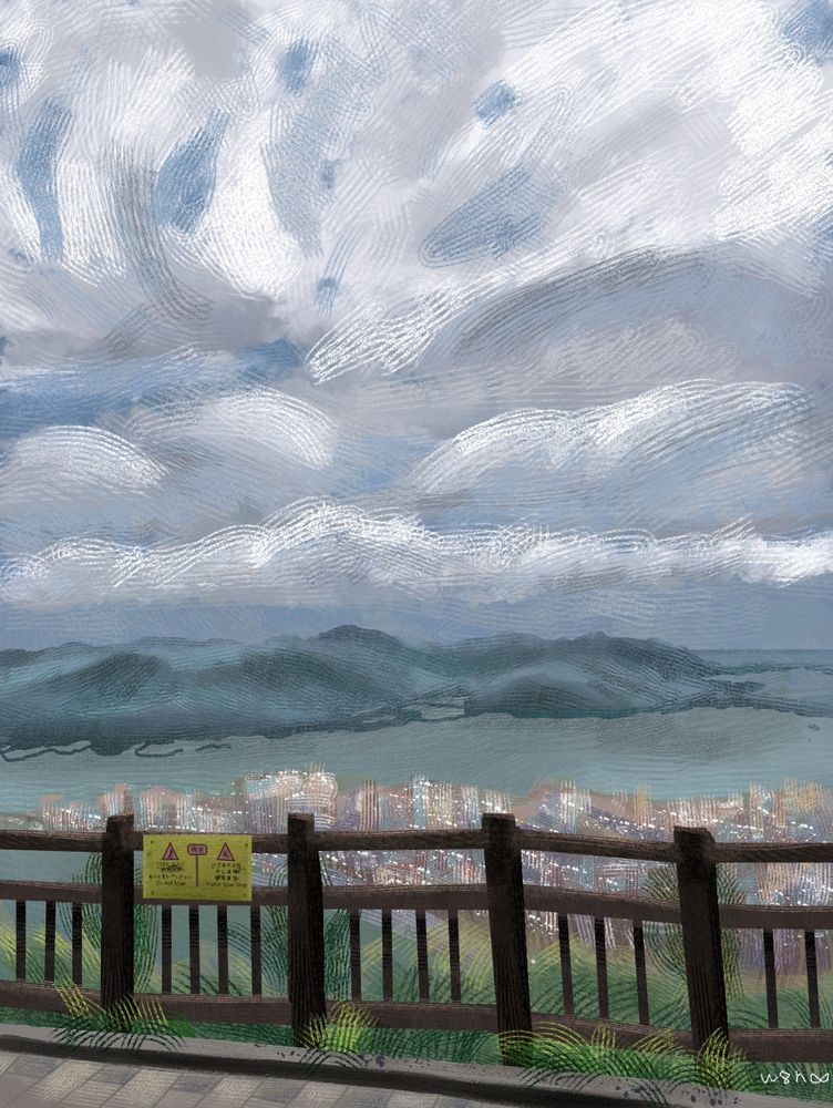 A study of a photo taken from a fenced sidewalk atop a mountain on Jeju Island, Korea. It depicts the city below, and across the sea, more green mountains. The sky is grey and cloudy.