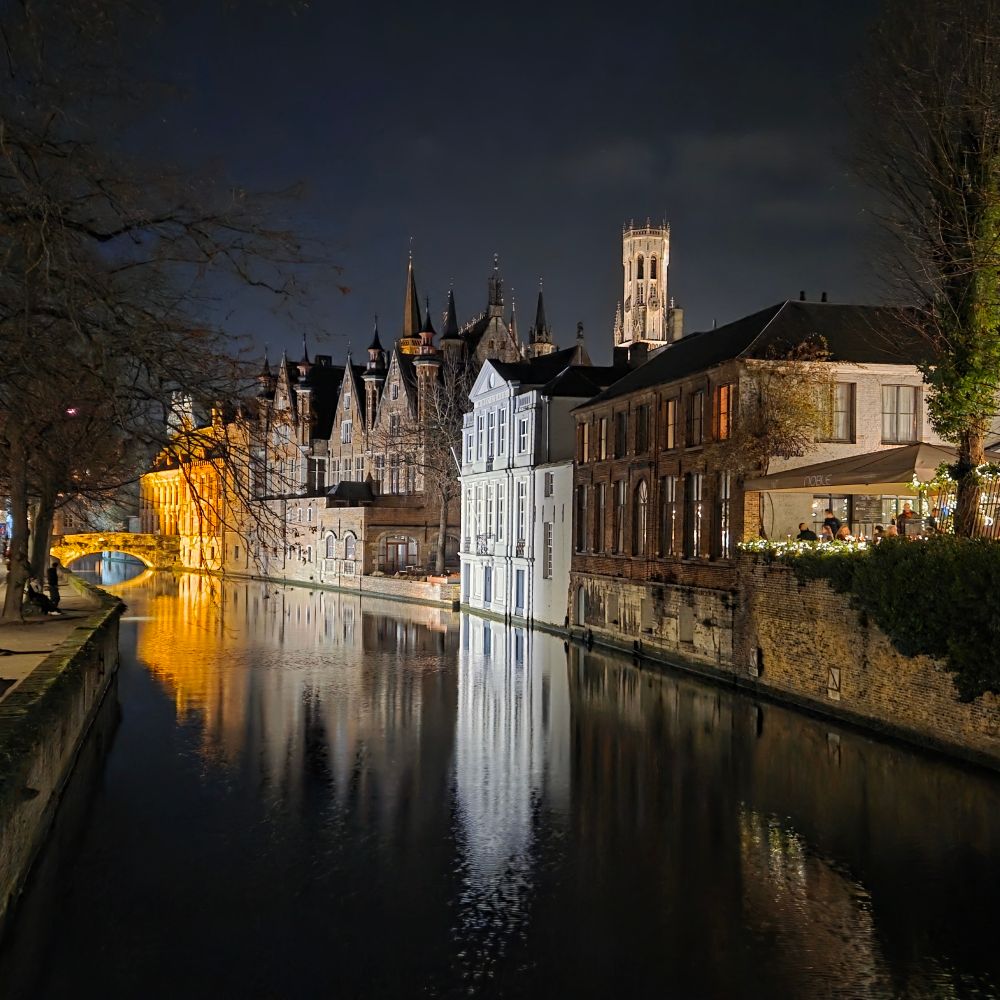 The classic view from Meebrug, with floodlit buildings by the canal.