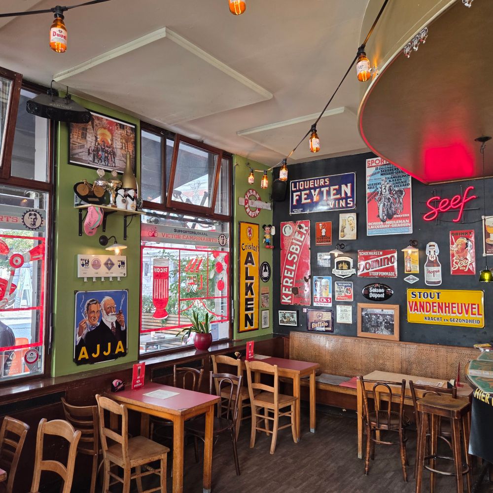Interior of Cafe Mombasa, Antwerp. Walls have numerous old brewery signs.
