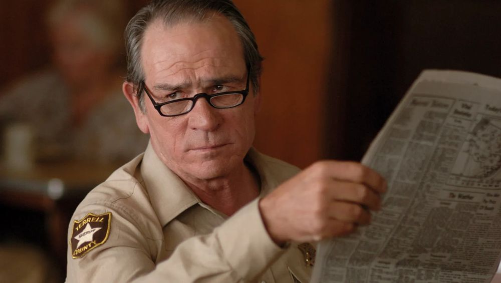 a still from the film 'No Country for Old Men'. Tommy Lee Jones' character looks disapprovingly to someone out of frame