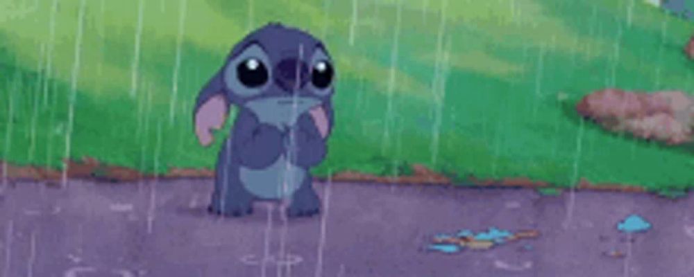 a cartoon character is standing in the rain with his hands on his face .