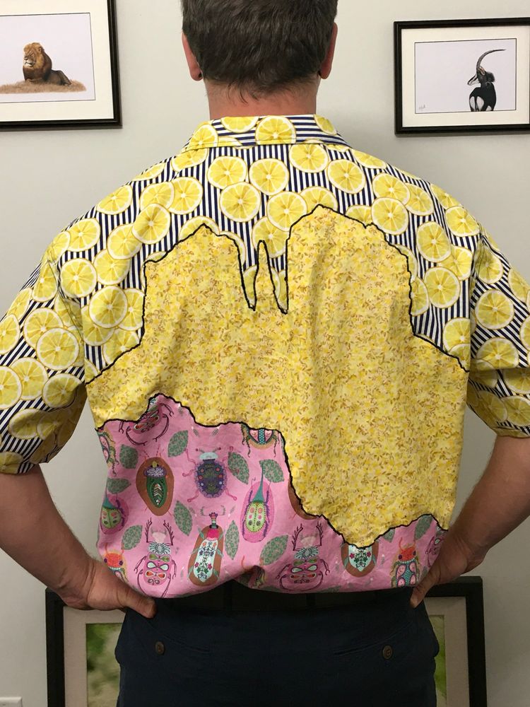 Back of the same shirt, featuring the same three fabrics in a landscape design. 