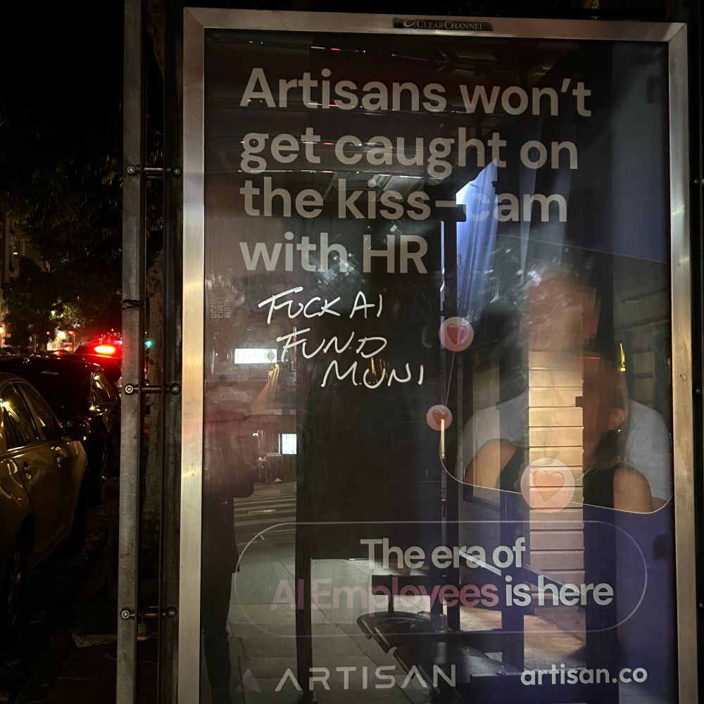 graffiti at a muni stop, “fuck AI fund muni”