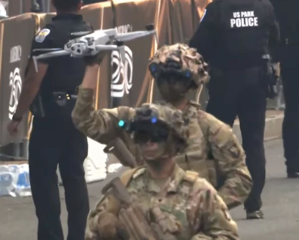A soldier carries a drone above his head rather than actually flying it. Unclear if he was making whooshing noises while walking. 