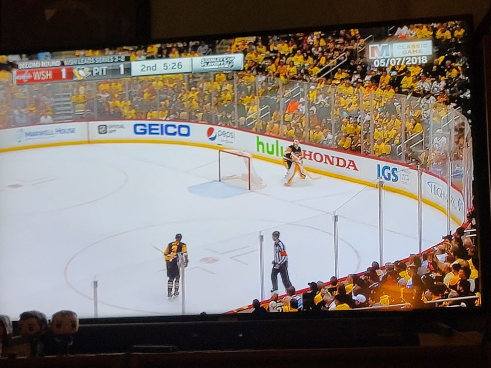 A hockey game between the Washington Capitals and Pittsburgh Penguins, late in the 2nd period. It is game 6 of a second round playoff series between the 2 teams, date 5/7/2018, Capitals leading 3 games to 2. The Capitals would go on to win the game on an overtime goal from Evegeny Kuznetsov, beating their rivals that had knocked them out of the playoffs multiple times in the recent years before. The Capitals would go on to beat the Tampa Bay Lightning in the Eastern Conference Final in 7 games and then the Vegas Golden Knights in 5 games in the Stanley Cup Final, winning the franchise's first Stanley Cup, and the only one to date.