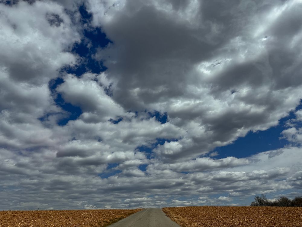 sky with clouds above an empty field 