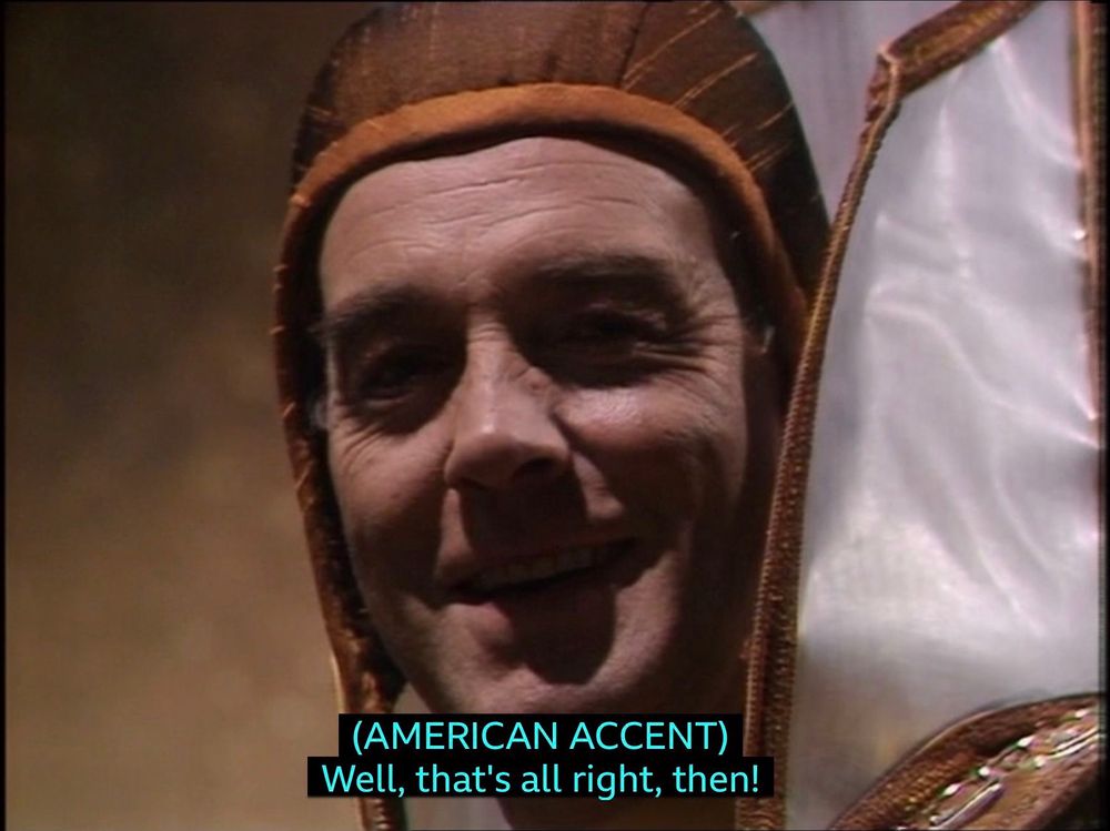 The Valeyard grinning, apparently saying in an American accent: “Well, that’s all right, then!”.