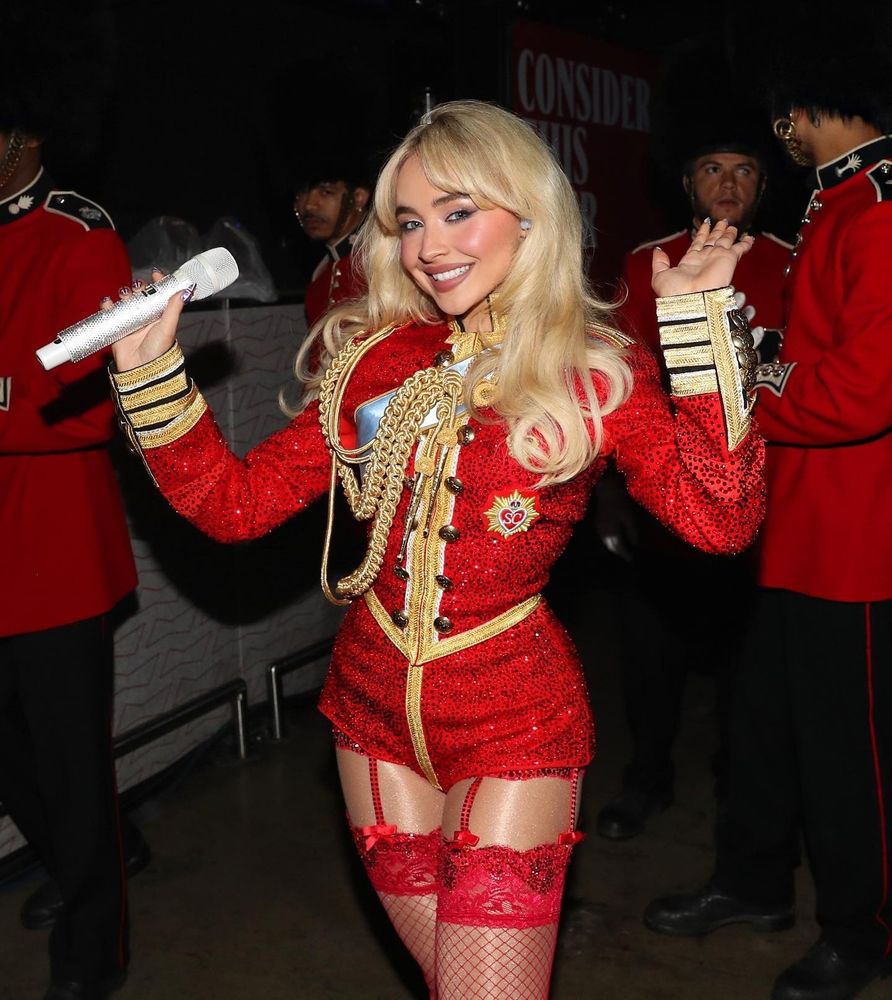 Sabrina Carpenter in a red outfit that resembles the one worn by Neil Patrick Harris as the Toymaker.