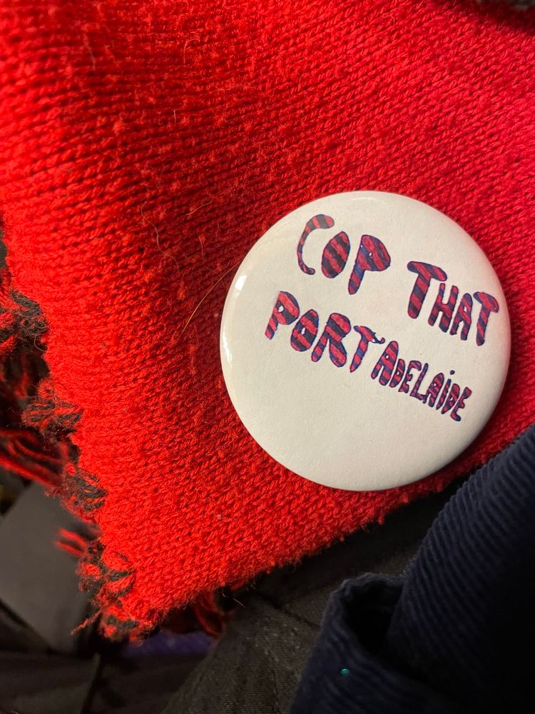 A photo of a badge reading “cop that port adelaide”