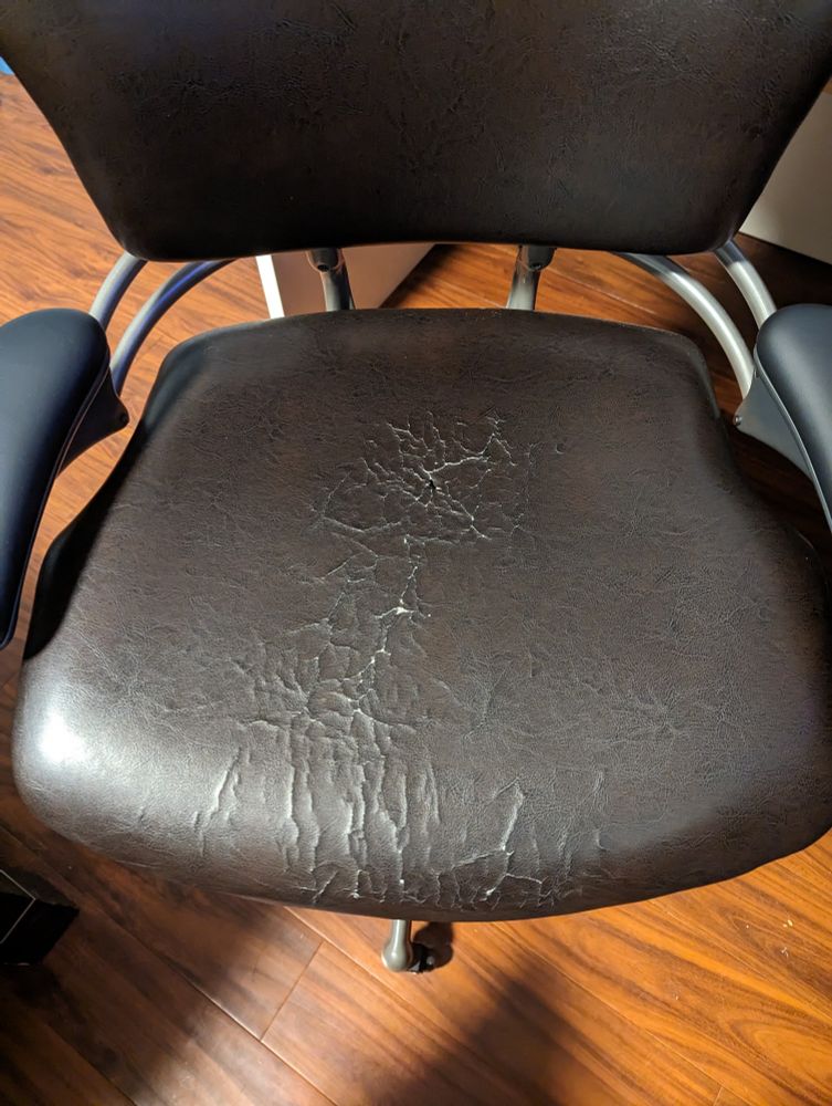 Desk chair with scratchy cracked vinyl seat