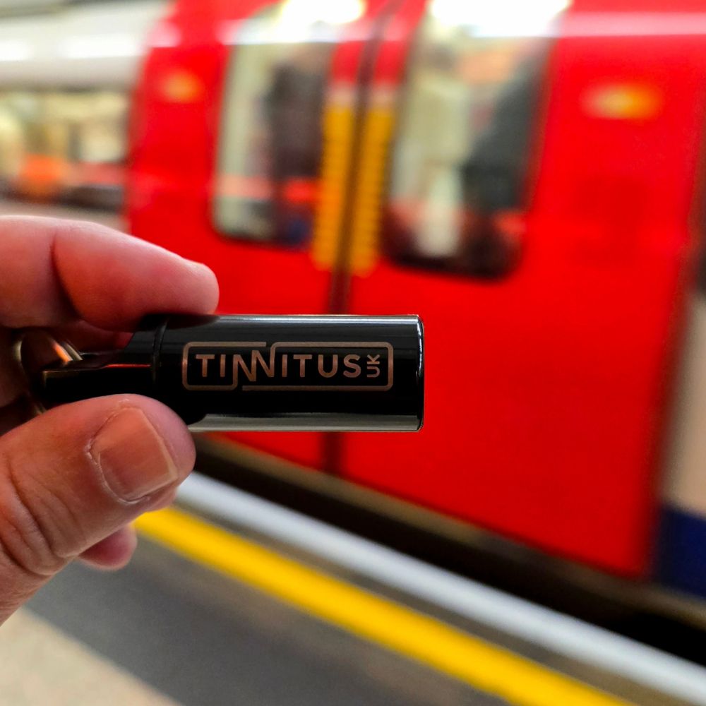 Tinnitus UK earplugs held at a London Underground station