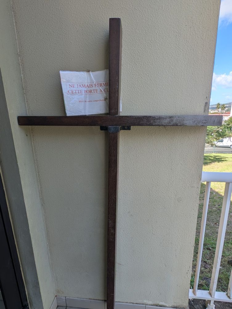 Croix avec le message : "Ne jamais fermer cette porte à clef"