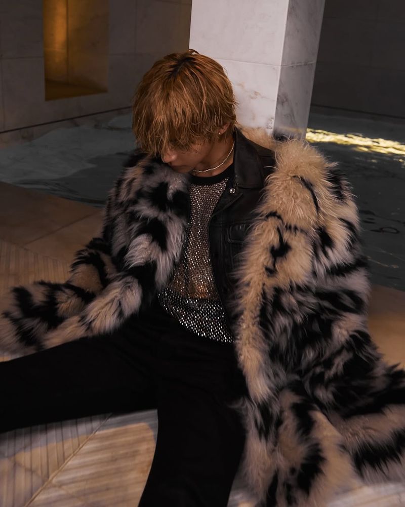 Taehyung posing with a leopard print coat for photographer Kim Hee June