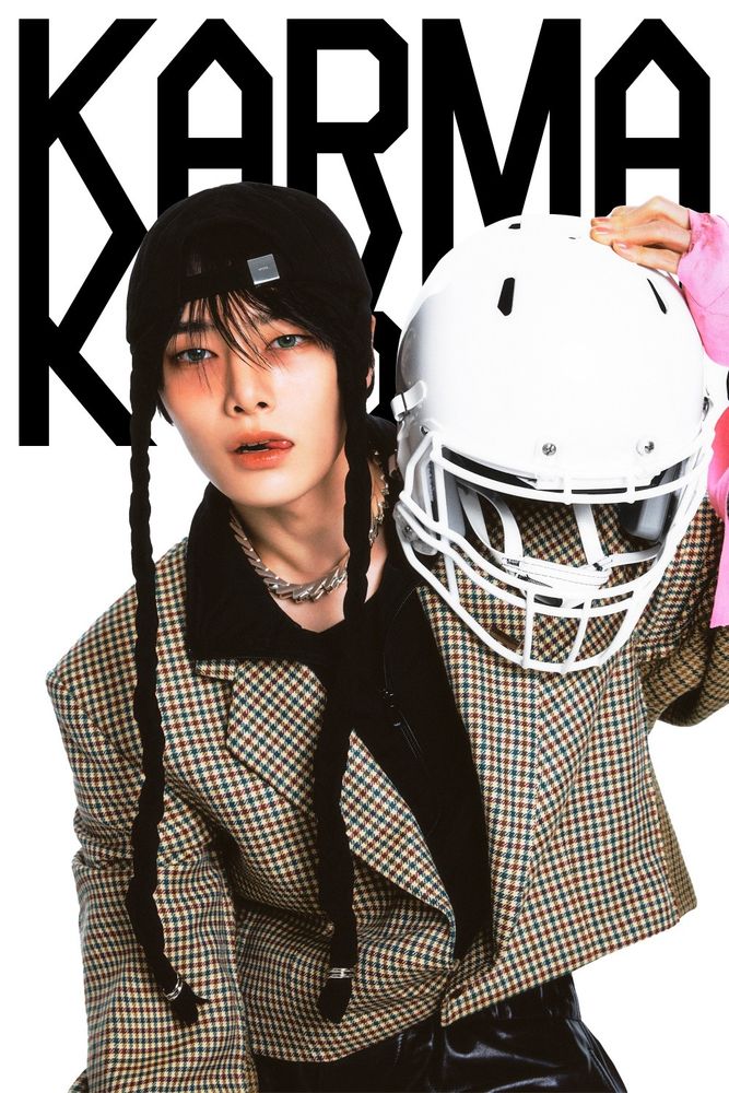 Jeongin's Karma photo concept, holding a hockey (?) helmet, tongue to the side