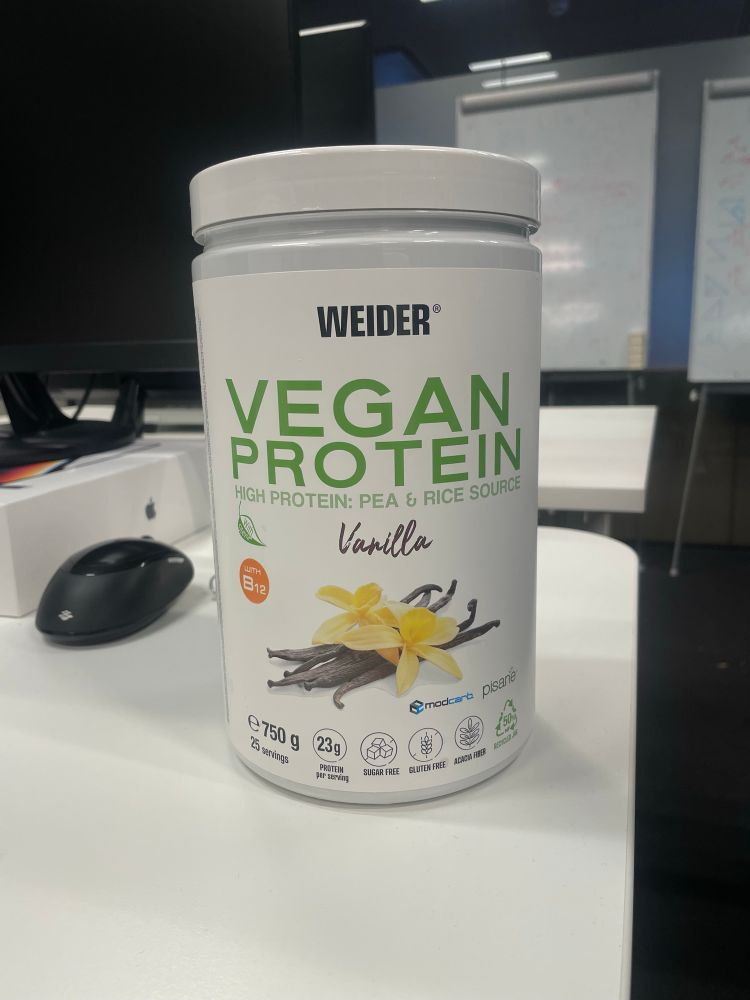A plastic container of vegan protein of Weider brand