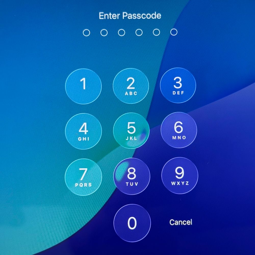 Passcode screen on iPadOS with liquidy glass buttons