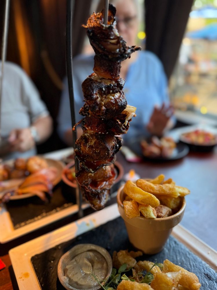 Hanging chicken kebab with chips