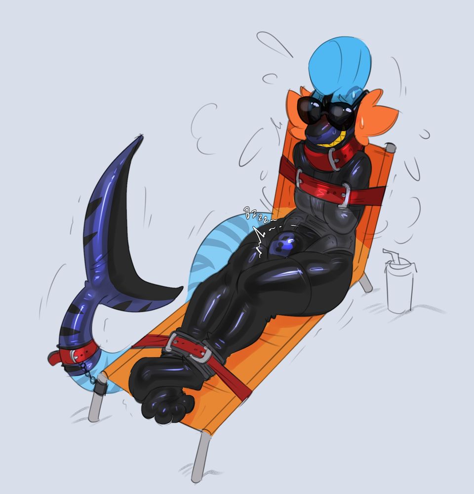 Kip on a lounge chair tied down to it in a latex suit and a stratjacket along with a cool pair of oversized sunglasses, a muzzle with a grin on it and a tail sleeve to mimic more of a sharks.
