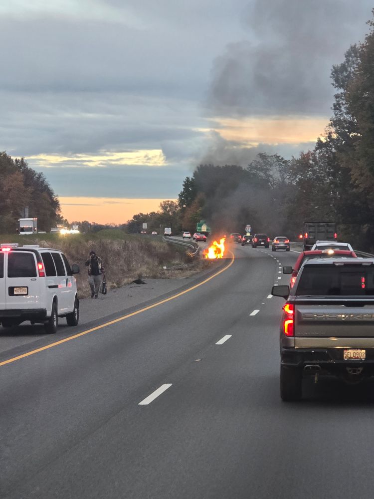Car actively on fire on the highway with traffic going around.

(Yes I believe that driver is ok from what I saw)