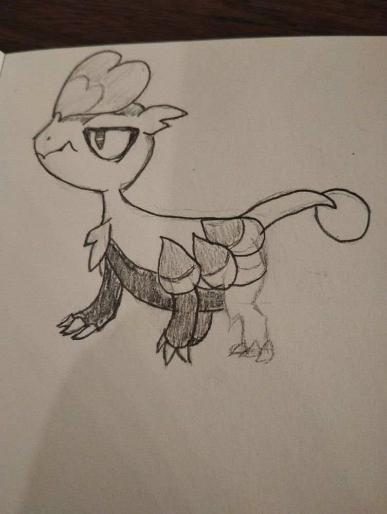 A page of a sketchbook with a pencil drawing of a Jangmo-o. The back left leg is still sketched and not fully drawn