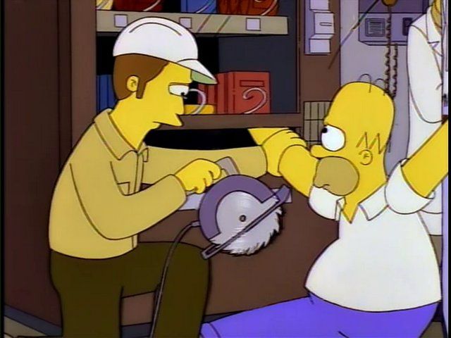 A man in a hard hat has a circular saw which he is about to use to cut Homer Simpson‘s arms off. Homer’s arms are trapped in two vending machines, but only because he won’t let go of the items he’s trying to take out of them