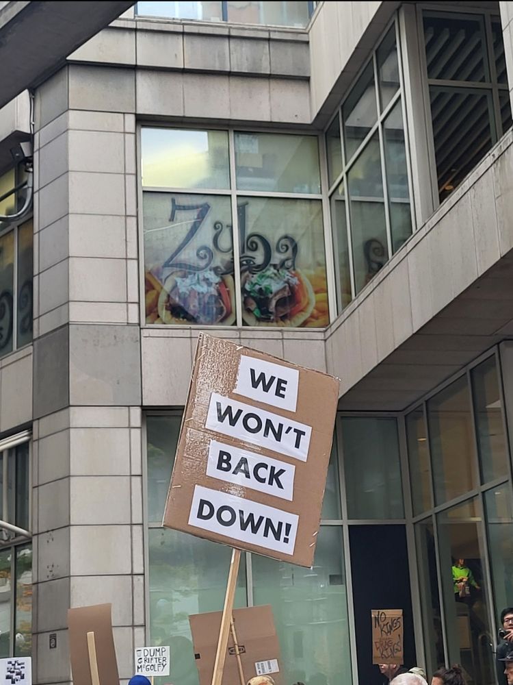 Sign reads "We won't back down"
