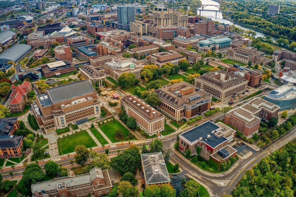 Aerial view of college campus, with river in background