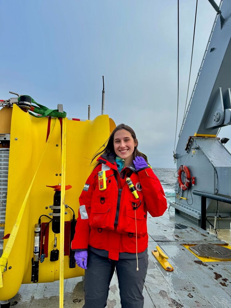 Daniella stands in front of Clio the AUV on the deck of the RV Atlantic Explorer during the C-CoMP March 2025 cruise. Photo by Fadime Stemmer.
