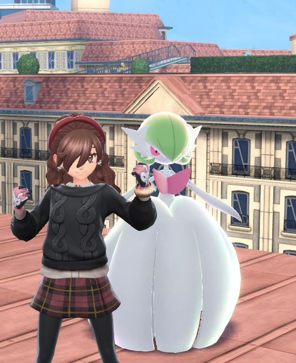 a girl in a stylish outfit posing with her mega gardevoir 