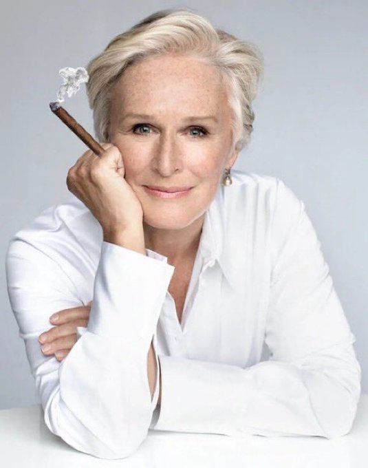 Glenn close holding a cigar. 